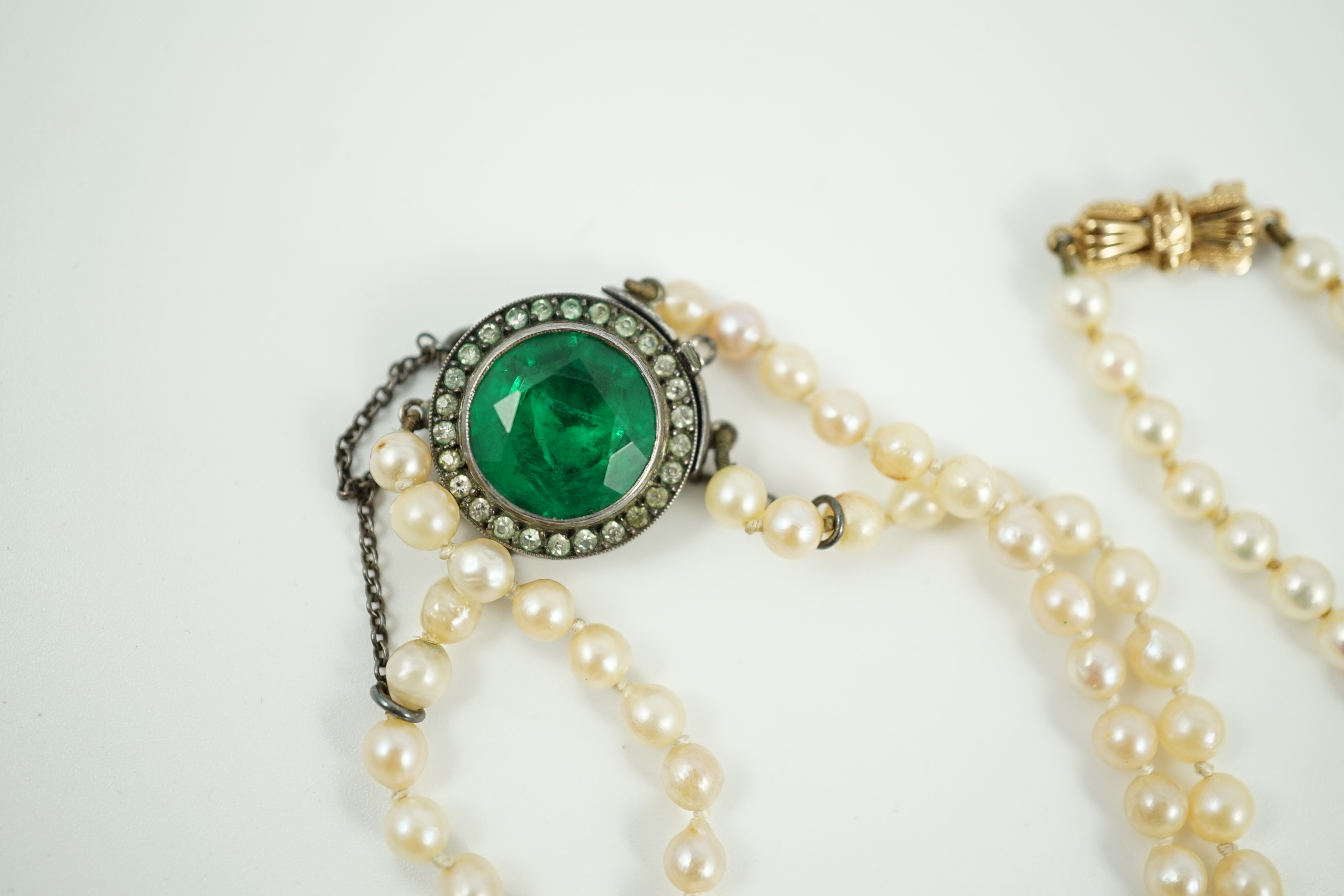 A twin strand graduated cultured pearl necklace, with white metal and two colour paste set clasp, 40cm, a single strand cultured pearl necklace, with 9ct gold clasp and a similar bracelet.